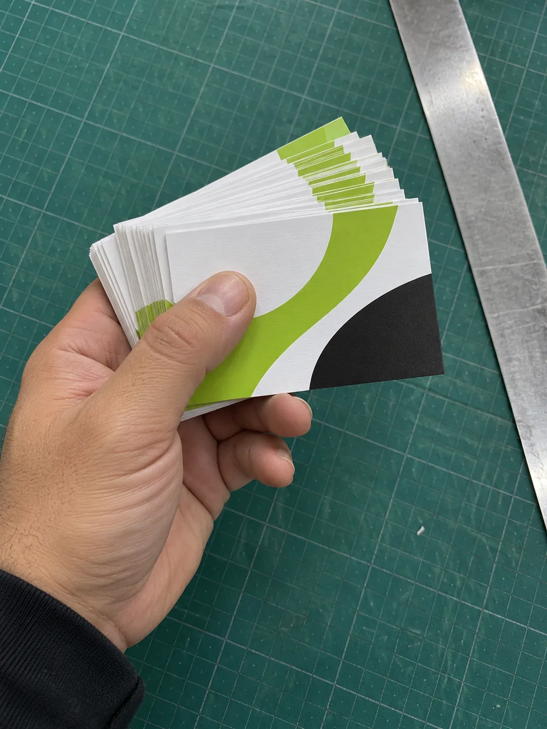 Hand holding freshly cut business cards